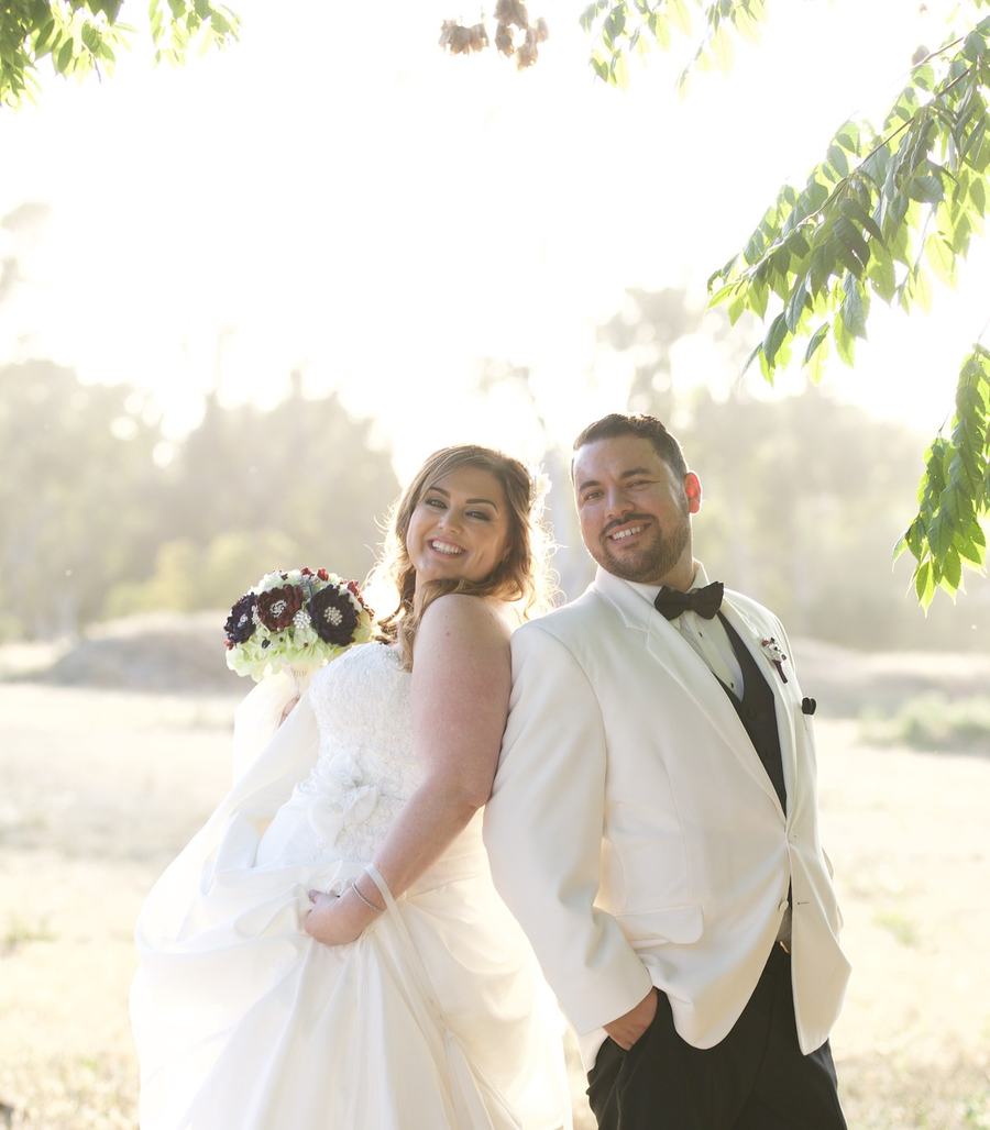 Renzo and Stacia Torres on their wedding day, holding each other close