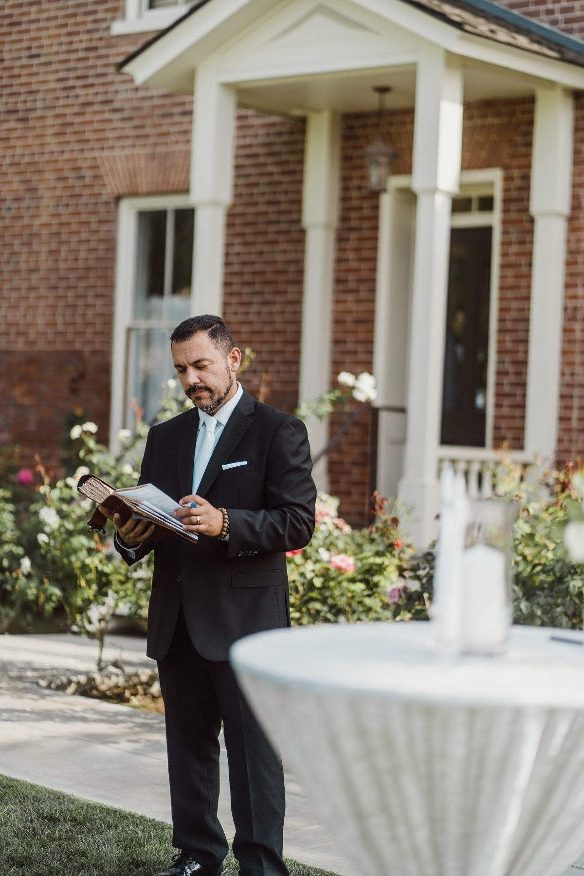 Renzo Torres preparing for a ceremony, reading from his ceremony book